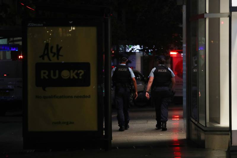 BONDI JUNCTION, AUSTRALIA - APRIL 13: NSW police move along Oxford Street outside Westfield Bondi Junction on April 13, 2024 in Bondi Junction, Australia. Six victims, plus the offender, are confirmed dead following an incident at Westfield Shopping Centre in Bondi Junction, Sydney. (Photo by Lisa Maree Williams/Getty Images)